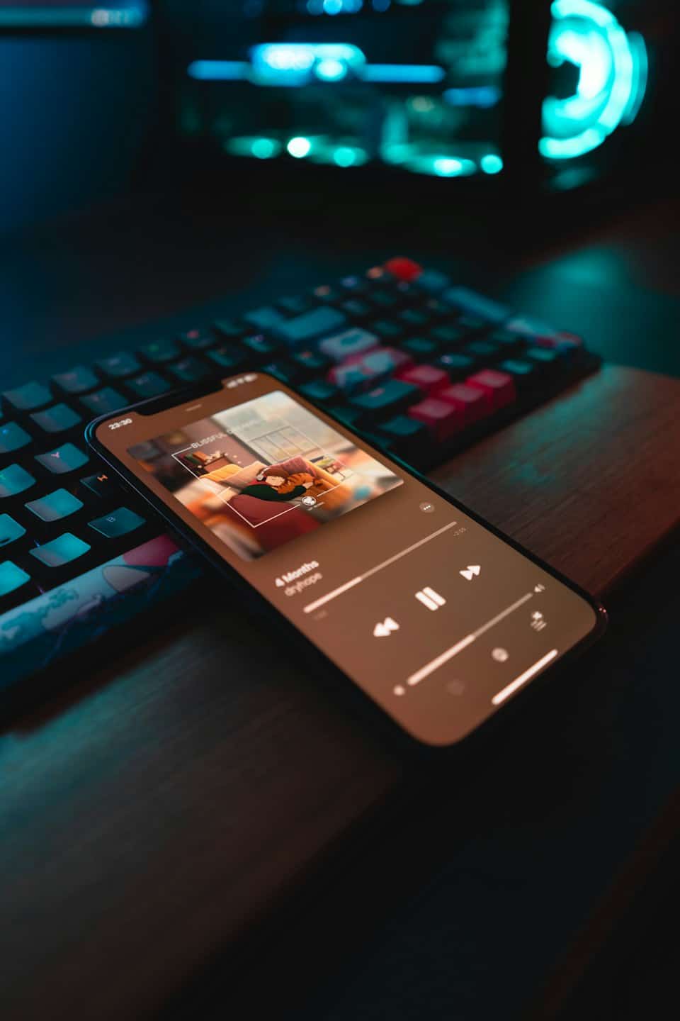 Smartphone mit Musik-Player auf einem Holztisch.